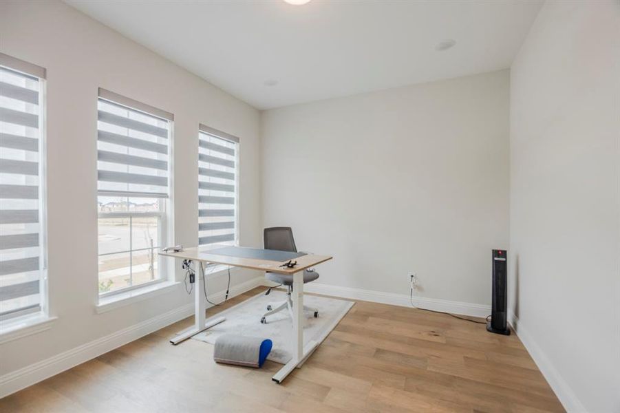 Office with baseboards and light wood finished floors