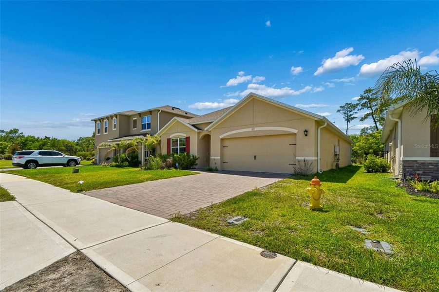 Front exterior of a new home in Riviera Bella, Debary, FL, highlighting curb appeal (Image 25).
