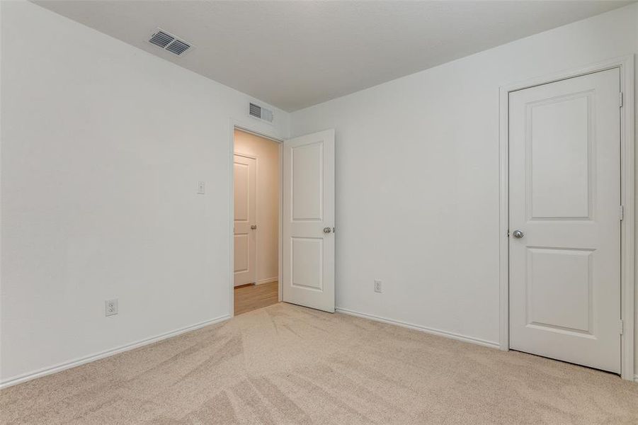 Unfurnished room with light colored carpet