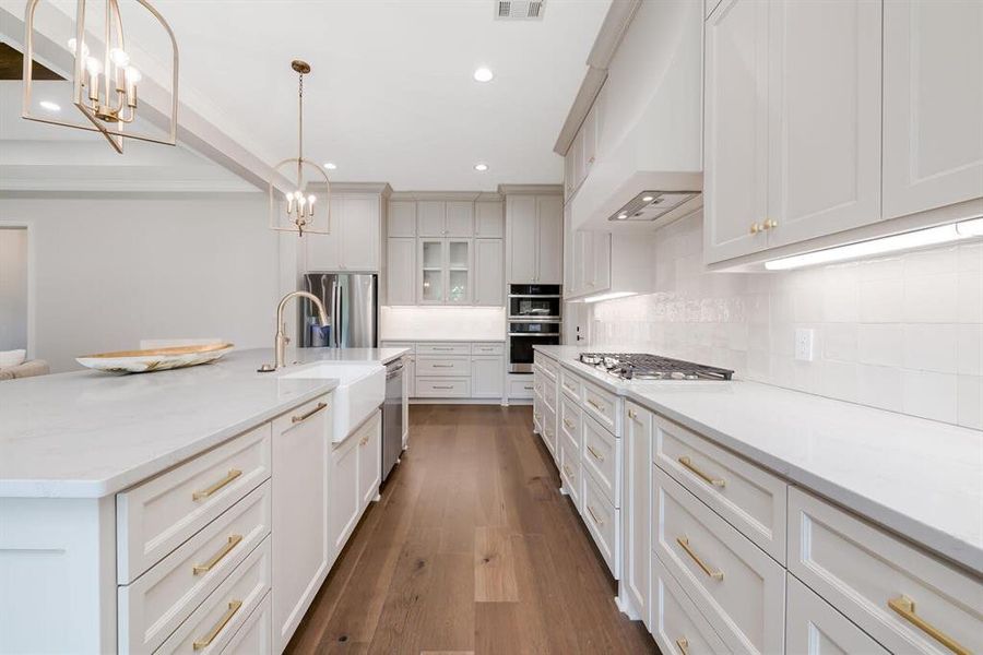 Kitchen featuring a chandelier, custom range hood, backsplash, dark wood finished floors, and recessed lighting Kitchen featuring a chandelier, custom range hood, backsplash, dark wood finished floors, and recessed lighting