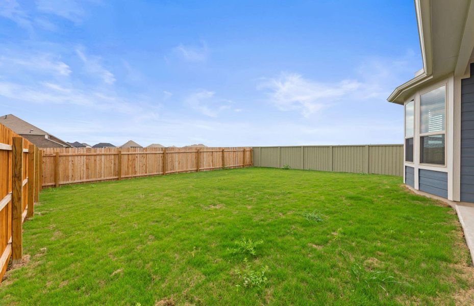 Front exterior of a new home in Santa Rita Ranch, Liberty Hill, TX, highlighting curb appeal (Image 20).