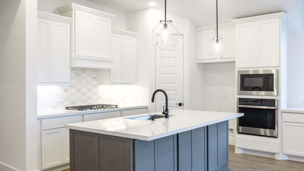 Kitchen featuring stainless steel appliances, decorative backsplash, light countertops, white cabinets, and recessed lighting Kitchen featuring stainless steel appliances, decorative backsplash, light countertops, white cabinets, and recessed lighting