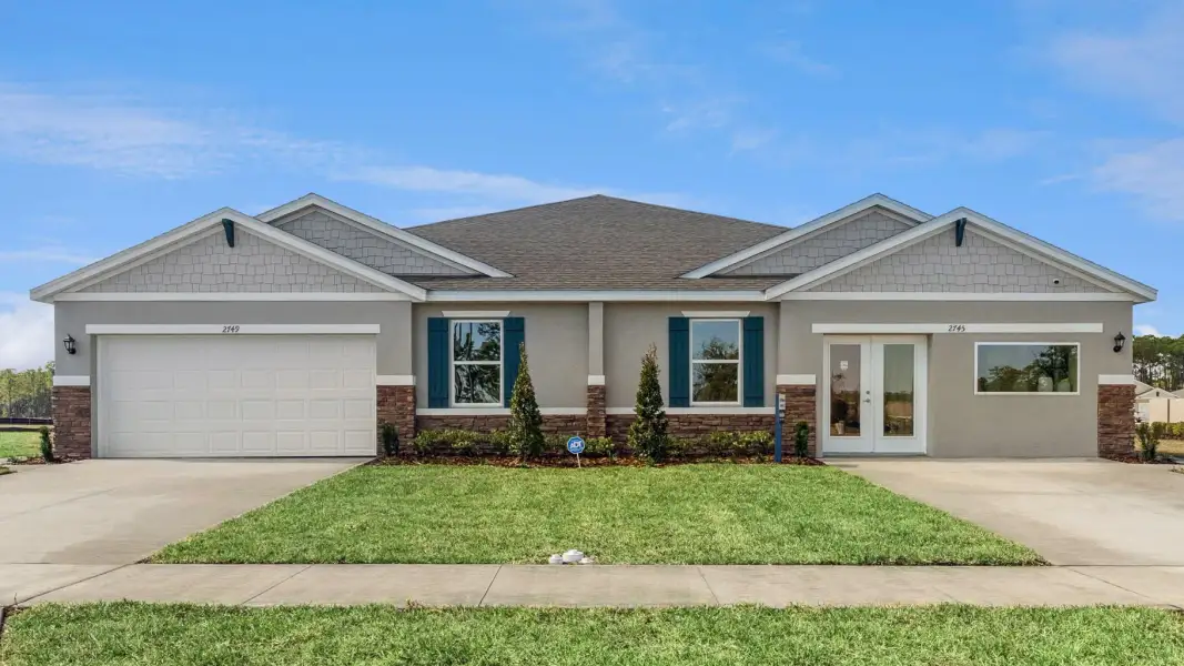 Front exterior of a new home in Halifax Plantation Villas, Ormond Beach, FL, highlighting curb appeal (Image 1). Front exterior of a new home in Halifax Plantation Villas, Ormond Beach, FL, highlighting curb appeal (Image 1).
