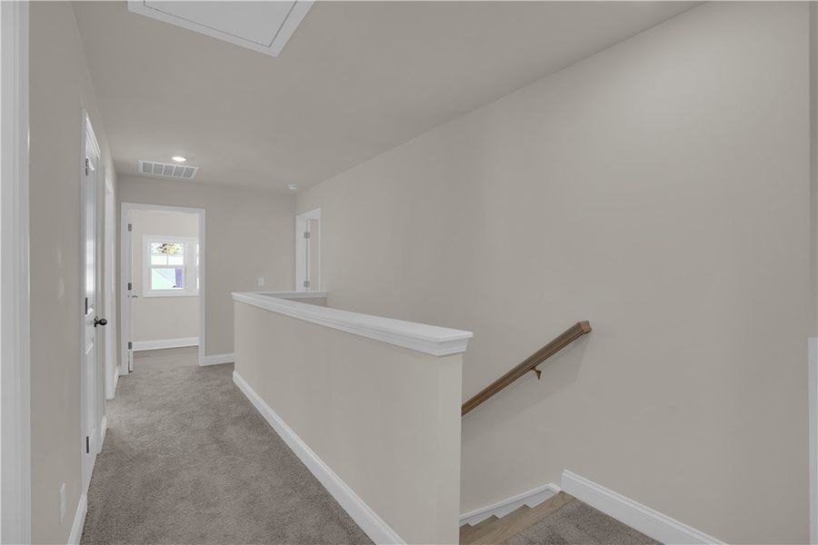 This bright hallway connects various rooms, offeri This bright hallway connects various rooms, offeri