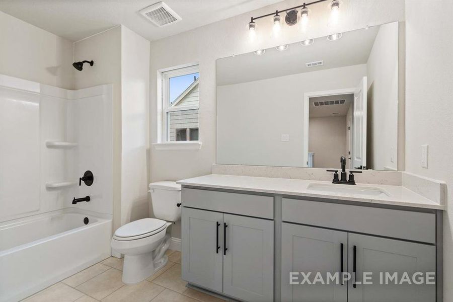 Full bathroom featuring tile patterned flooring, vanity, toilet, and tub / shower combination