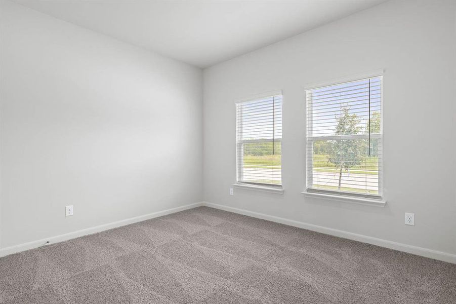 Unfurnished room with carpet and baseboards Unfurnished room with carpet and baseboards