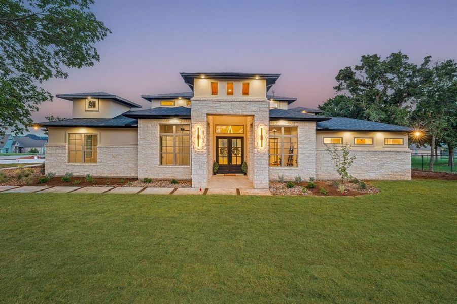 Prairie-style home with a lawn