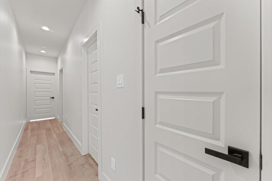 All of the secondary bedrooms and bathroom are across the home from the primary suite.