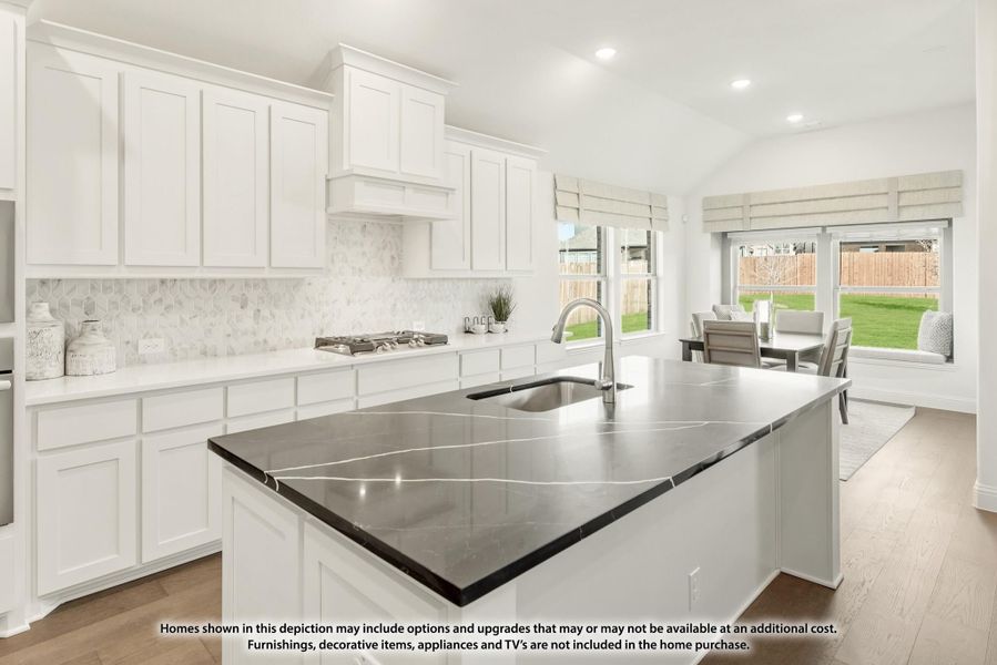 Kitchen with white cabinets, dark marble island, tile backsplash, and hardwood floors open to dining area Kitchen with white cabinets, dark marble island, tile backsplash, and hardwood floors open to dining area