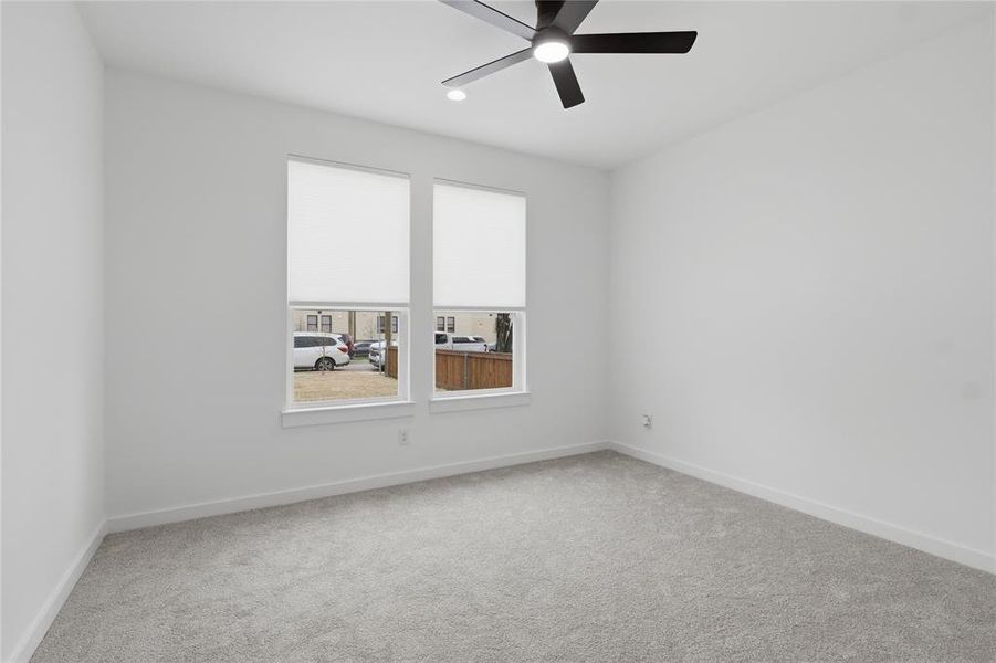 Empty room with carpet floors and ceiling fan Empty room with carpet floors and ceiling fan