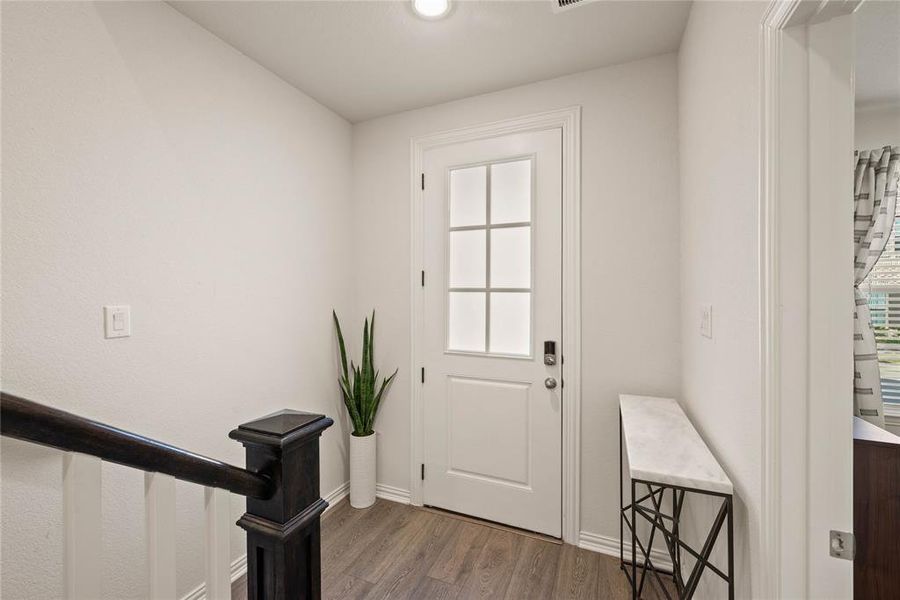 Entrance foyer with wood-type flooring