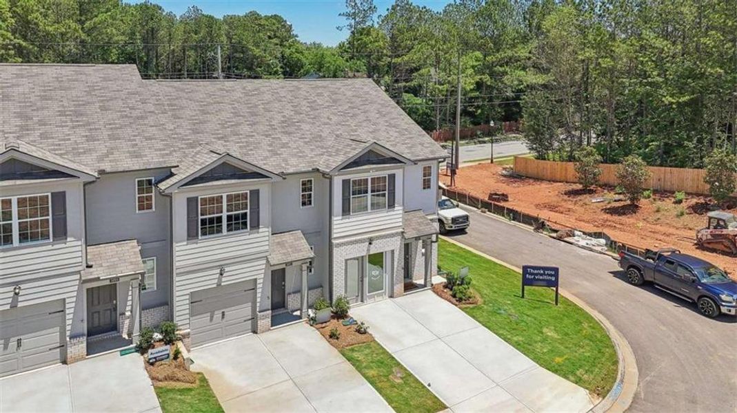 Front exterior of a new home in Wellington Park, Lithonia, GA, highlighting curb appeal (Image 20).