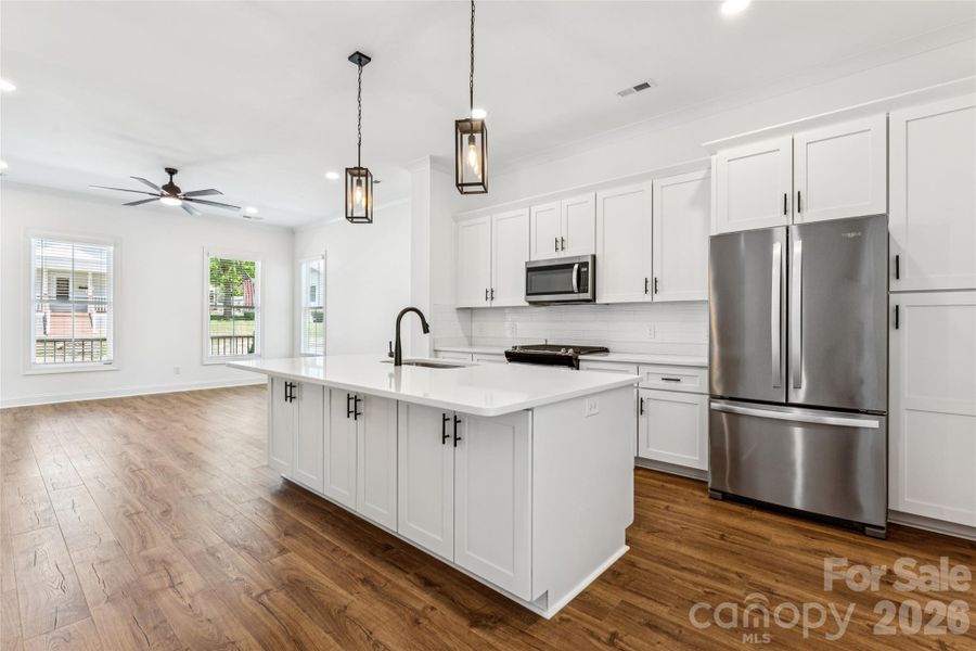 Open concept, tall ceilings, tons of natural light, large kitchen with ample cabinets.. even on the other side of the island