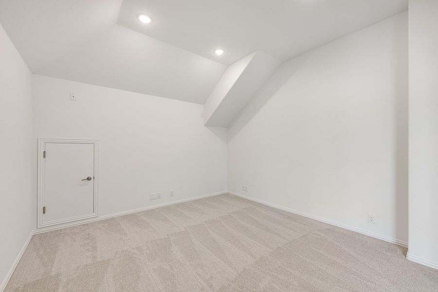 Empty bonus room with vaulted ceiling, recessed lighting, and beige carpet Empty bonus room with vaulted ceiling, recessed lighting, and beige carpet
