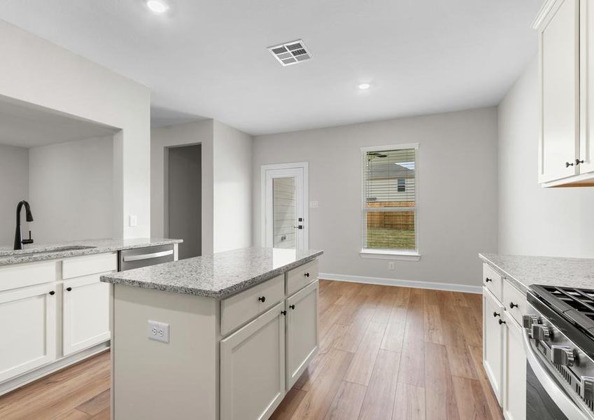 This kitchen has a beautiful granite island.