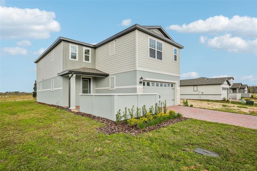 Front exterior of a new home in Springs at Lake Alfred - Classic Series, Lake Alfred, FL, highlighting curb appeal (Image 24).