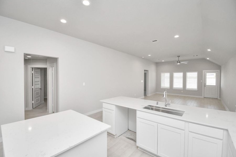 All of this overlooks your expansive family room, creating a perfect space for culinary delights and family gatherings. Sample photo of completed home with similar floor plan. Actual colors and selections may vary.