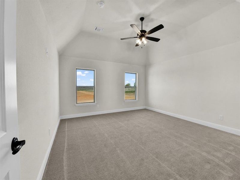 Unfurnished room with baseboards, visible vents, carpet, and vaulted ceiling Unfurnished room with baseboards, visible vents, carpet, and vaulted ceiling