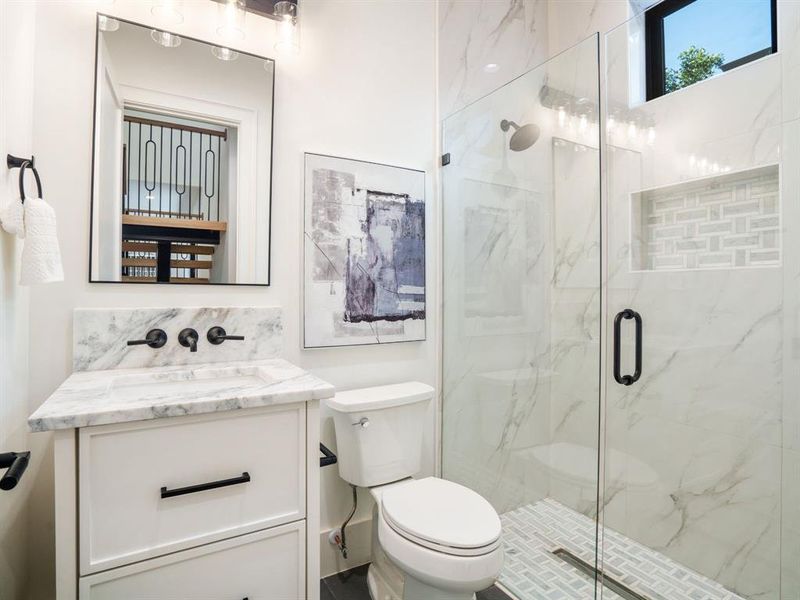 Full bath with vanity and a marble finish shower