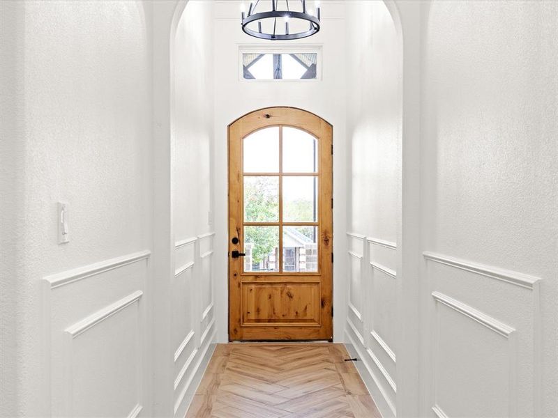 Doorway to outside with healthy amount of natural light and arched walkways