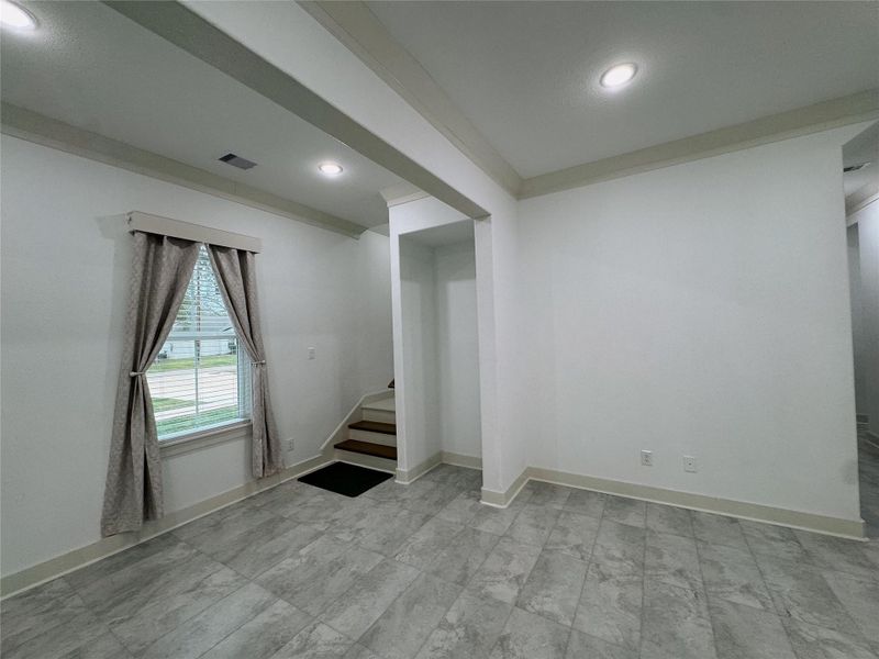 Bottom of staircase located off the downstairs living space that overlooks the front yard.