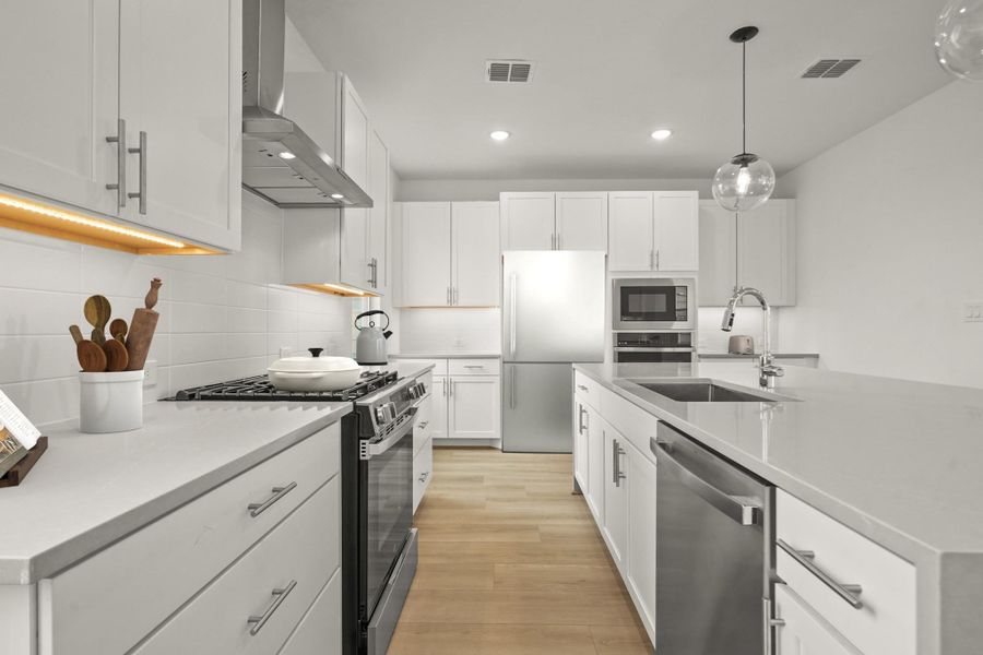 Stunning kitchen with quartz countertops and white cabinets (*Photo not of actual home and used for illustration purposes only.) Stunning kitchen with quartz countertops and white cabinets (*Photo not of actual home and used for illustration purposes only.)