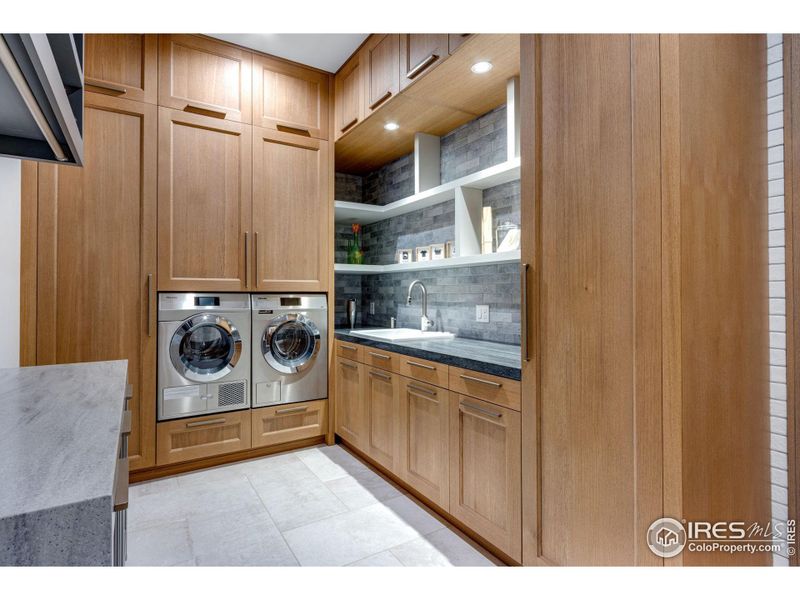 Lower-Level Laundry with lots of storage cabinets, drawers, and hampers. Lower level laundry is nearly identical