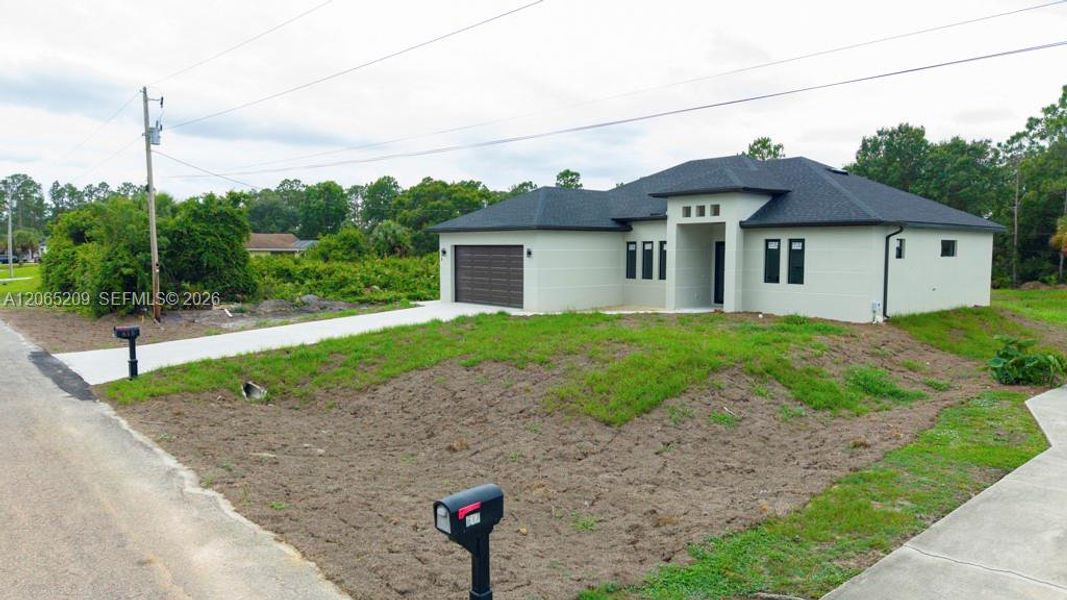 Front exterior of a new home in , Lehigh Acres, FL, highlighting curb appeal (Image 27).