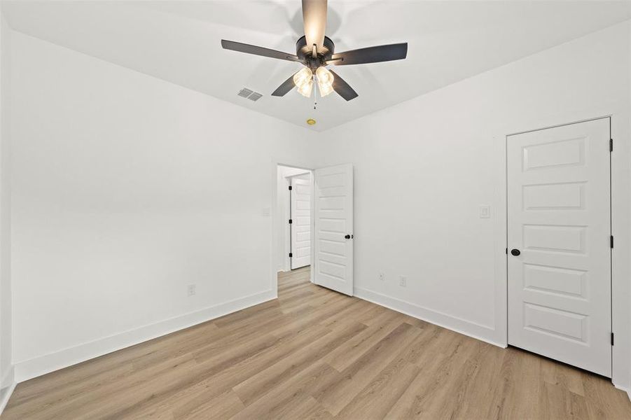 Unfurnished bedroom with light wood-style flooring and ceiling fan