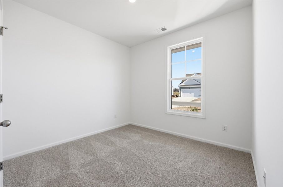 Unfurnished room featuring light colored carpet and baseboards
