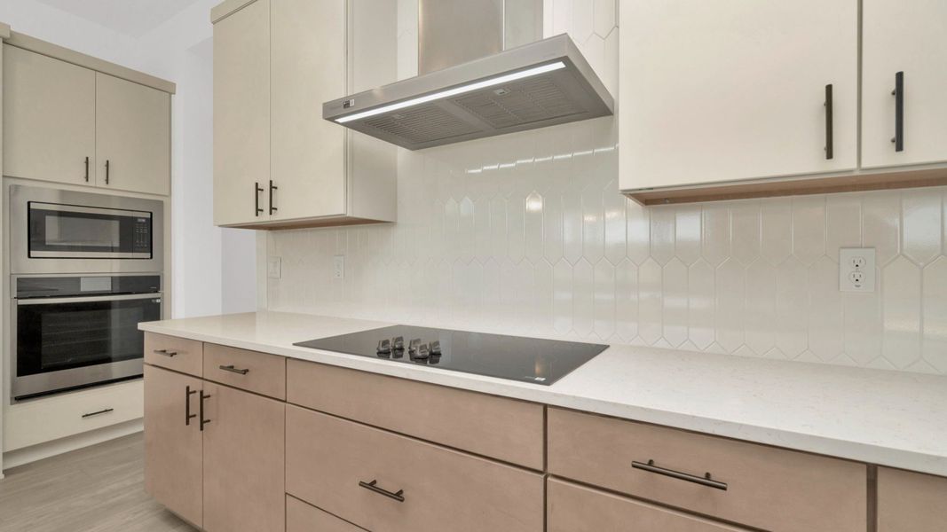 The Kitchen of a DRB Homes Grand Hawk which is offered as a home plan at Serengeti in Spring Hill, FL.