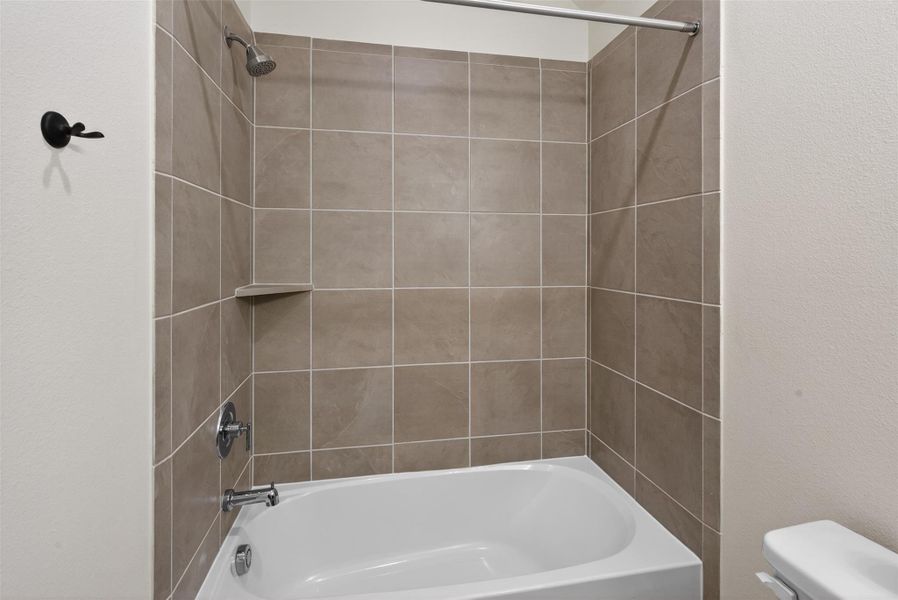 Tiled tub and shower combination with clean lines and durable finishes, designed for both everyday ease and timeless appeal. Tiled tub and shower combination with clean lines and durable finishes, designed for both everyday ease and timeless appeal.