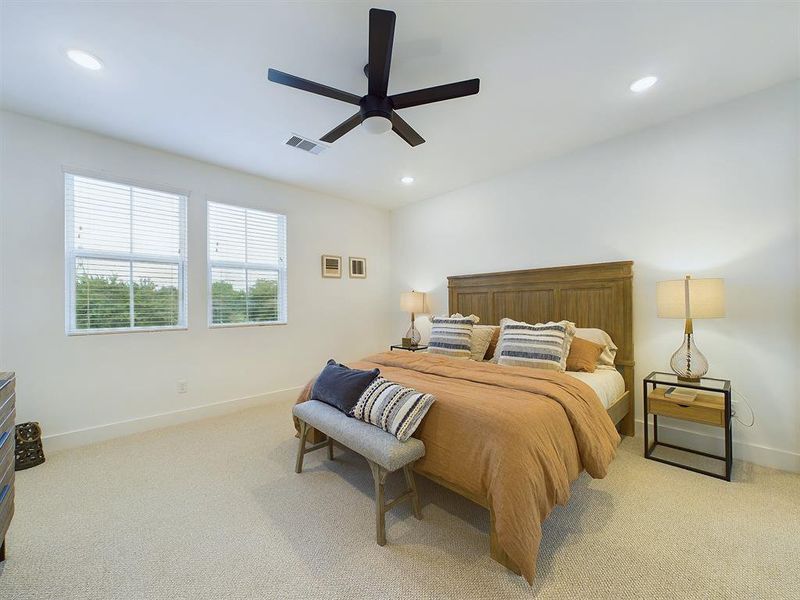 Elegant Primary Bedroom located on the 2nd floor. The high ceilings, with recessed lighting, are prewired and blocked for ceiling fans (not included).