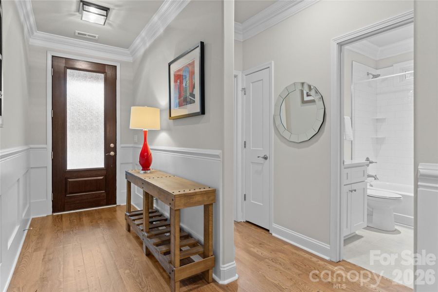 Lovely entry foyer with heavy millwork.  Handsome front door with waterfall glass for privacy.