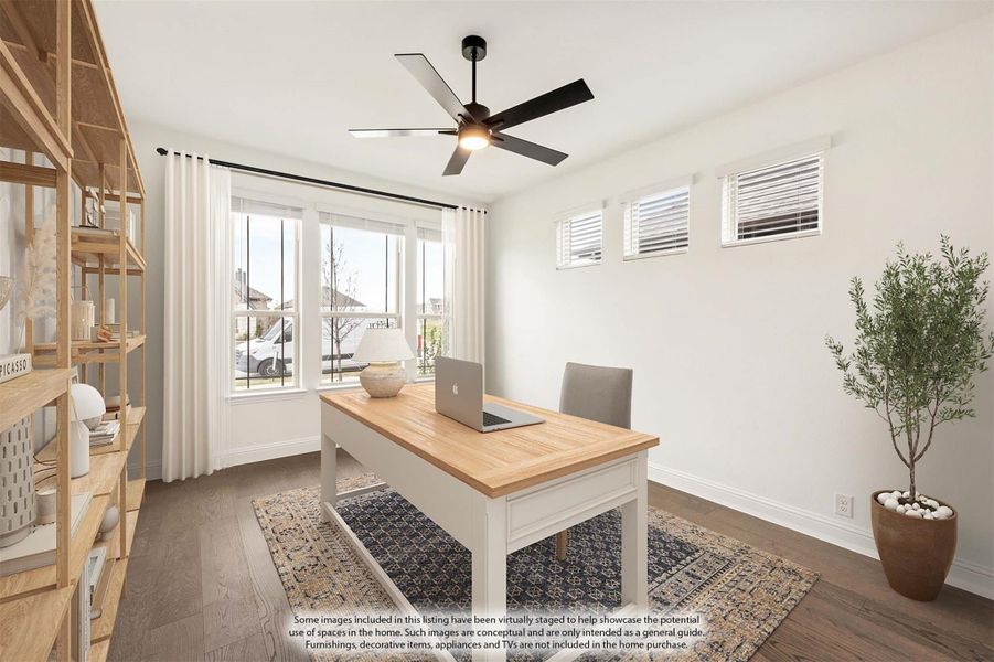 Home office with wood desk, ceiling fan, hardwood floors, and large windows providing natural light