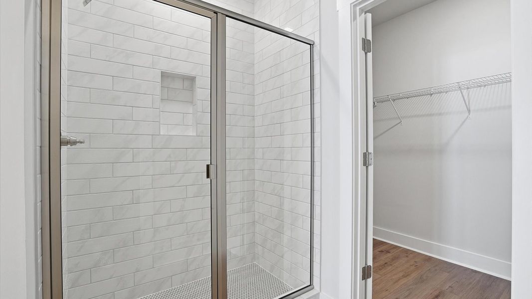Highly functional and elegant en-suite with dual vanities, tiled walk-in shower, and refined finishes at Village at Midway Highly functional and elegant en-suite with dual vanities, tiled walk-in shower, and refined finishes at Village at Midway