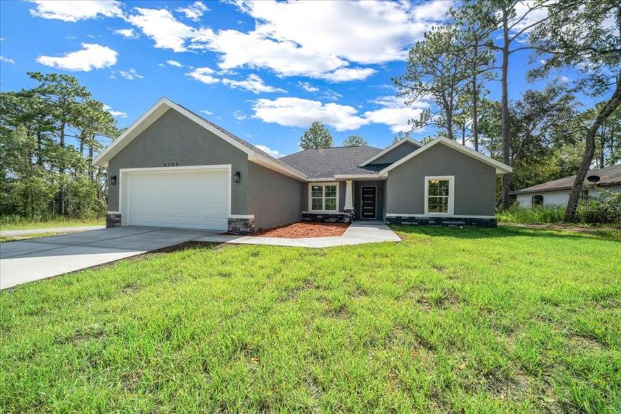 Front exterior of a new home in , Citrus Springs, FL, highlighting curb appeal (Image 19). Front exterior of a new home in , Citrus Springs, FL, highlighting curb appeal (Image 19).
