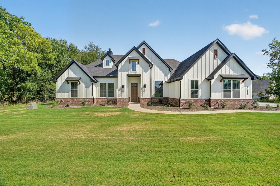Front exterior of a new home in Cartwright Ranch, Weatherford, TX, highlighting curb appeal (Image 1). Front exterior of a new home in Cartwright Ranch, Weatherford, TX, highlighting curb appeal (Image 1).