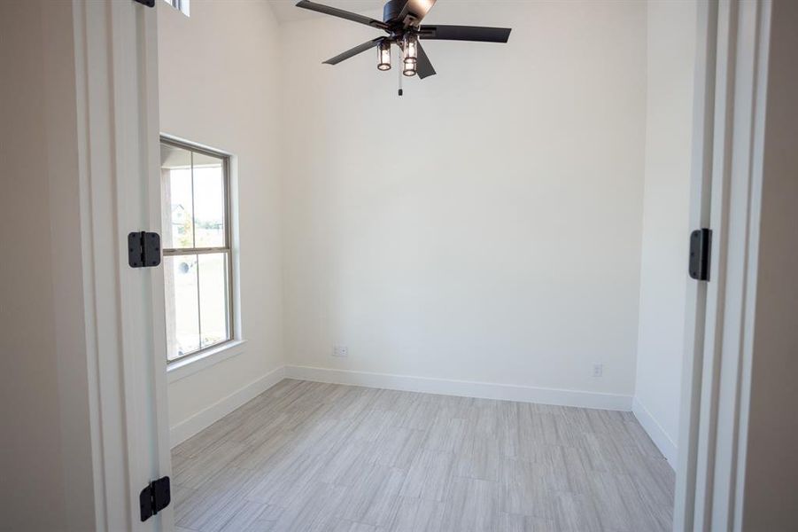 Spare room featuring light wood finished floors and ceiling fan Spare room featuring light wood finished floors and ceiling fan