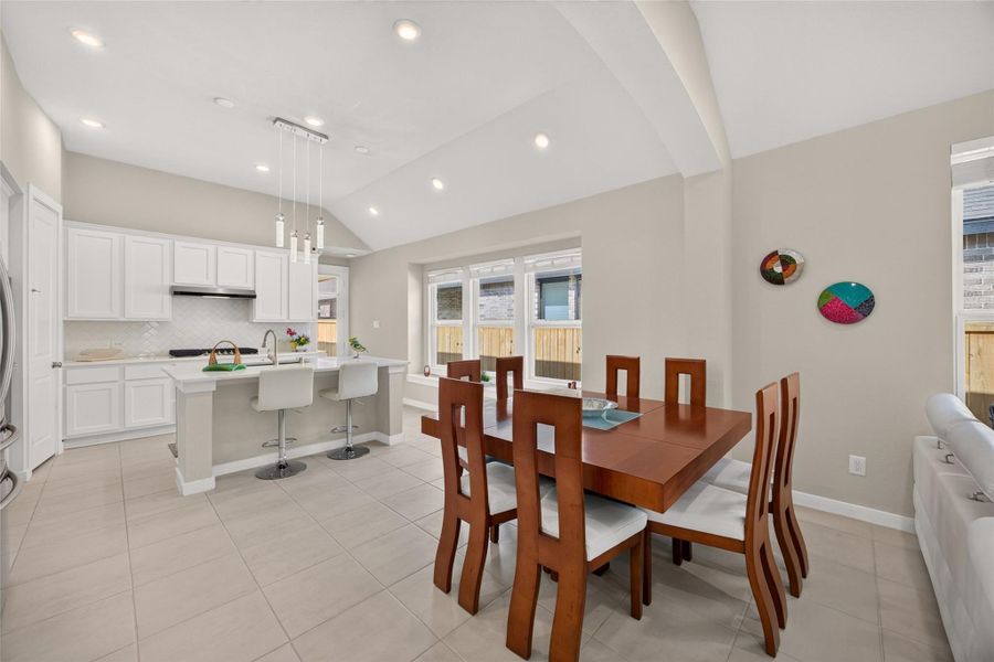 View of the dining area and kitchen from the living room. View of the dining area and kitchen from the living room.
