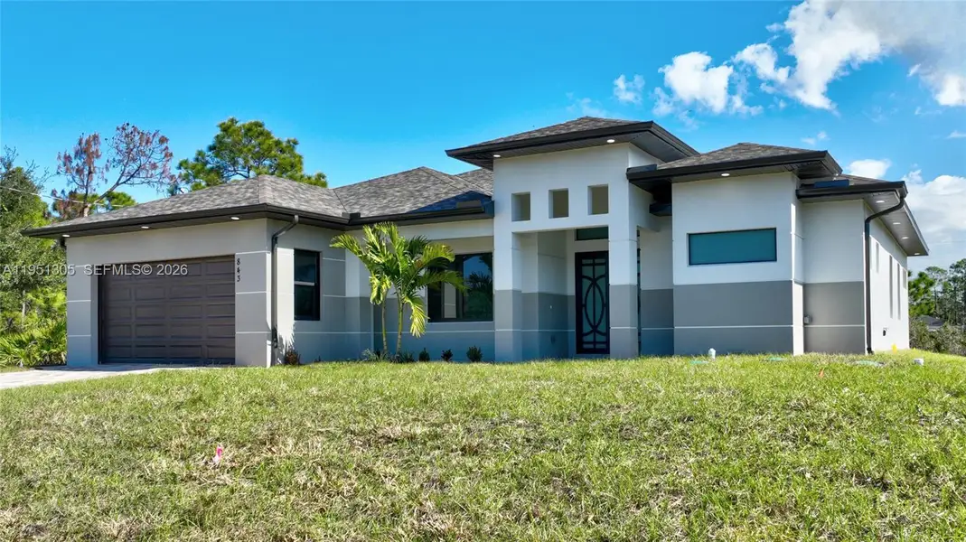 Front exterior of a new home in , Lehigh Acres, FL, highlighting curb appeal (Image 2). Front exterior of a new home in , Lehigh Acres, FL, highlighting curb appeal (Image 2).