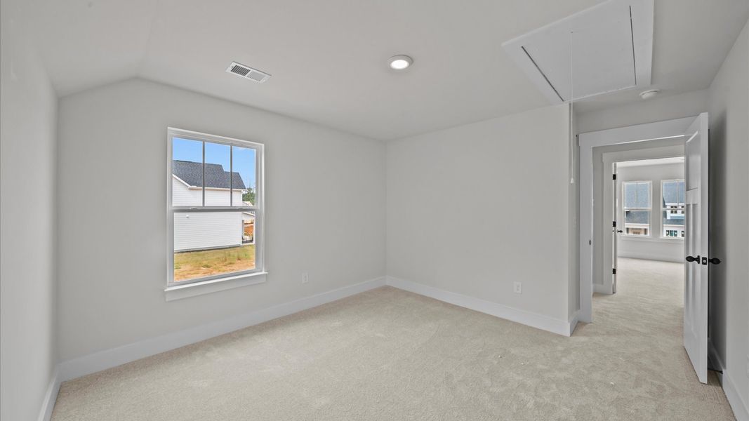 First-rate bedroom with plush carpeting and large windows that provide an open, airy feel