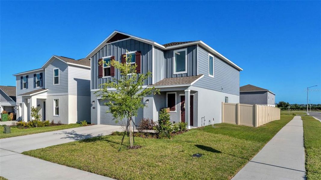 Front exterior of a new home in Peace Creek Reserve, Winter Haven, FL, highlighting curb appeal (Image 22).