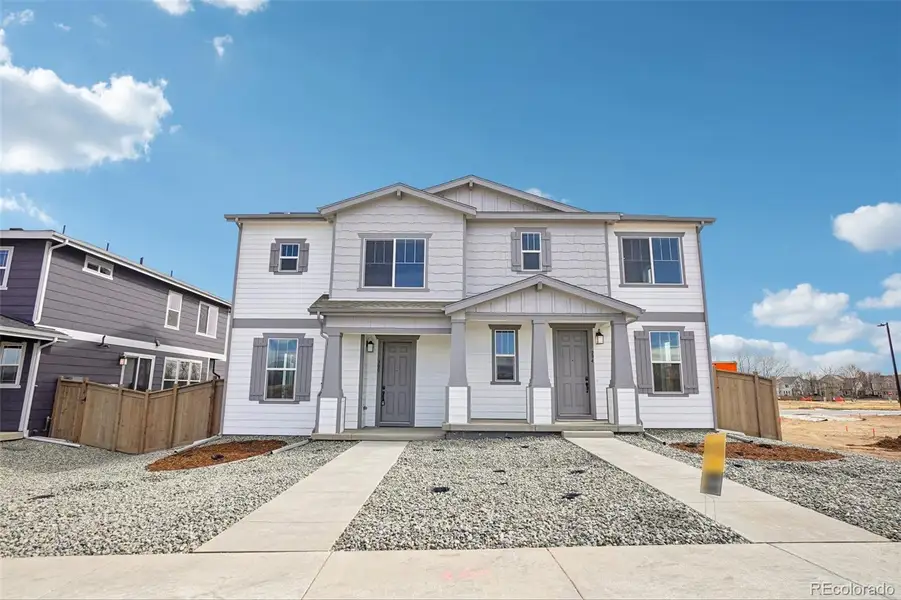 Front exterior of a new home in The Nest Villas at Canyon Creek, Erie, CO, highlighting curb appeal (Image 8).