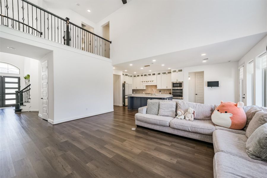 View of the island kitchen and catwalk from the family room. Extensive wood look vinyl plank flooring. View of the island kitchen and catwalk from the family room. Extensive wood look vinyl plank flooring.