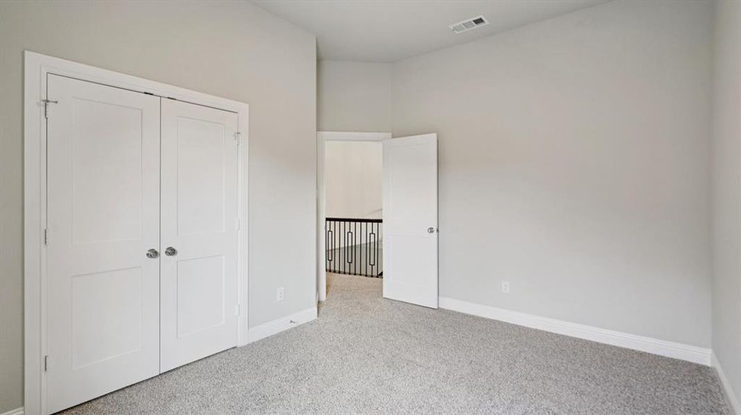 Unfurnished bedroom with carpet and a closet Unfurnished bedroom with carpet and a closet