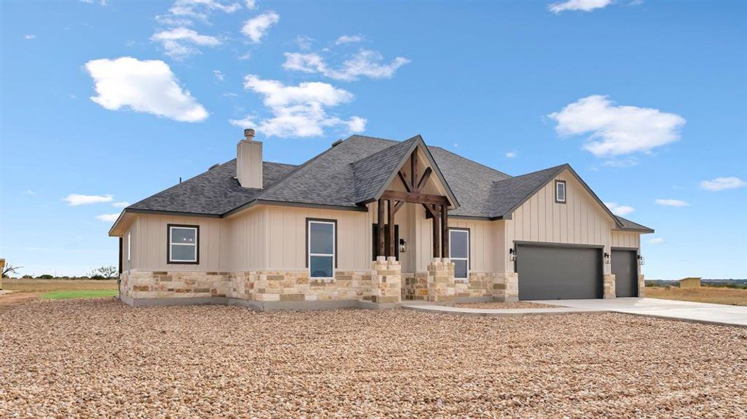 Natural stone accents and bold timber gables define this modern ranch facade. Natural stone accents and bold timber gables define this modern ranch facade.