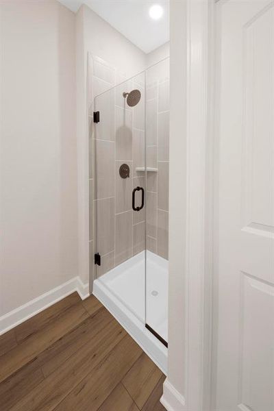 The shower has upgraded, glass doors with modern fixtures and shelves for storage of your favorite toiletries.