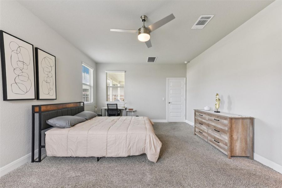 Carpeted bedroom with baseboards and ceiling fan Carpeted bedroom with baseboards and ceiling fan