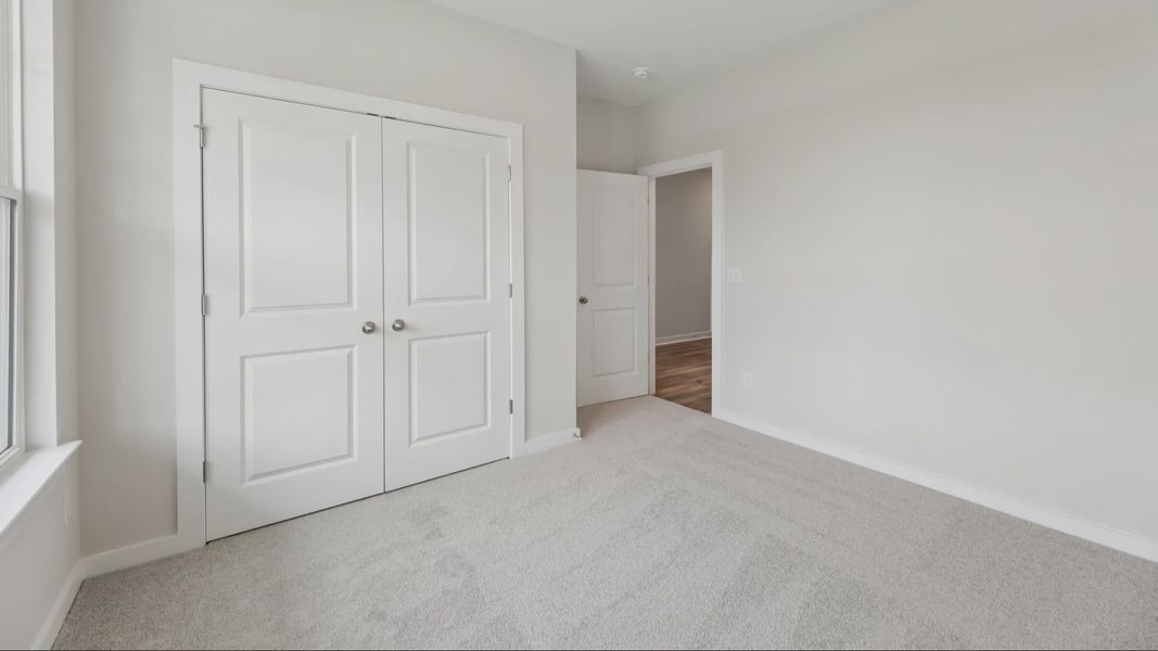 Bedroom with carpet and closet